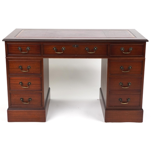 1111 - Mahogany twin pedestal desk with red tooled leather insert fitted with an arrangement of nine drawer... 