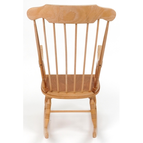 1144 - Lightwood rocking chair with check upholstered cushions, 102cm high