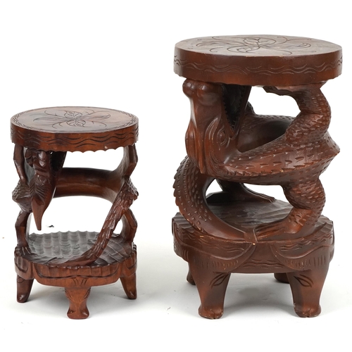 1055 - Two Chinese carved hardwood dragon design occasional tables, the largest 62cm high x 39cm in diamete... 