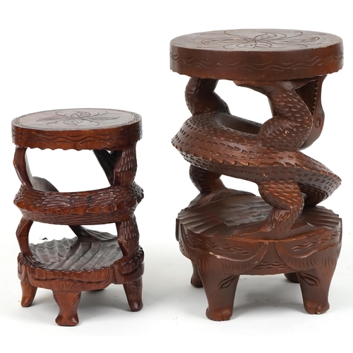 1055 - Two Chinese carved hardwood dragon design occasional tables, the largest 62cm high x 39cm in diamete... 