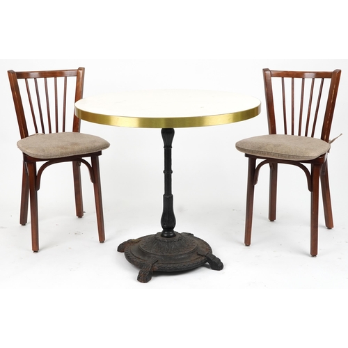 1129A - Contemporary circular bistro table with cast iron base and two mahogany chairs with cushions, the ta... 