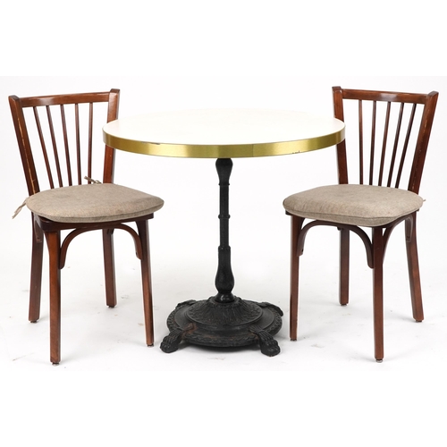 1187 - Contemporary circular bistro table with cast iron base and two mahogany chairs with cushions, the ta... 