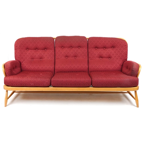 Ercol light elm Jubilee stick back three seater settee with red fleur de lis upholstered cushioned seats, 83cm H x 195cm W x 90cm D