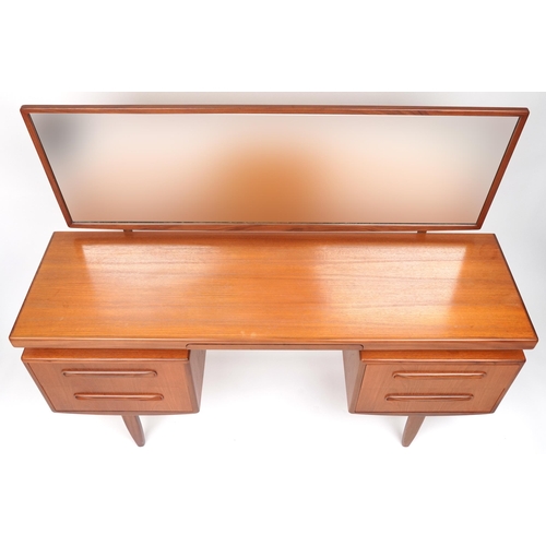 1006 - G Plan, Mid century Fresco teak dressing chest with mirrored back fitted with an arrangement of four... 