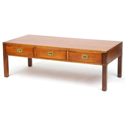 1103 - Military interest yew wood campaign style coffee table with three frieze drawers and brass mounts, 4... 