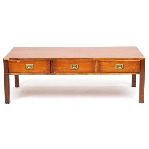 1103 - Military interest yew wood campaign style coffee table with three frieze drawers and brass mounts, 4... 