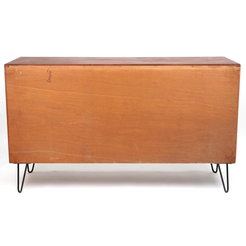 1003 - G Plan, Mid century Fresco teak sideboard on hairpin legs fitted with a door and an arrangement of t... 