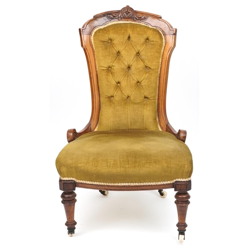 1062 - Victorian walnut side chair carved with a flower head and foliage having olive green button back uph... 