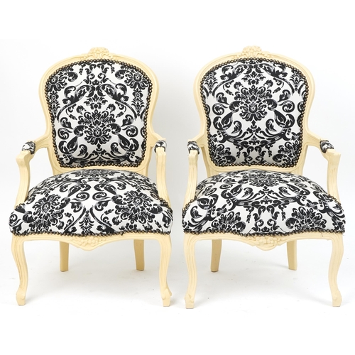 1106 - Pair of French style cream painted elbow chairs, each having cream and black floral upholstery, each... 