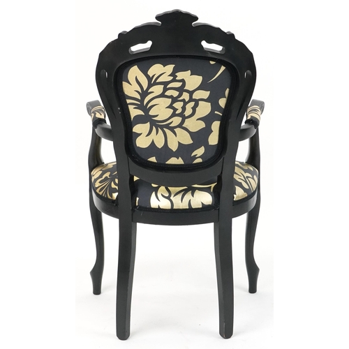 1218 - French style black painted elbow chair with black and gold floral upholstery, 103cm high