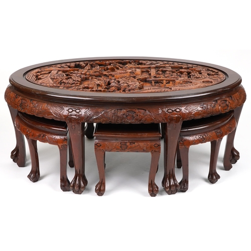 1143 - Nest of seven Chinese camphor wood occasional tables comprising an oval coffee table housing six occ... 