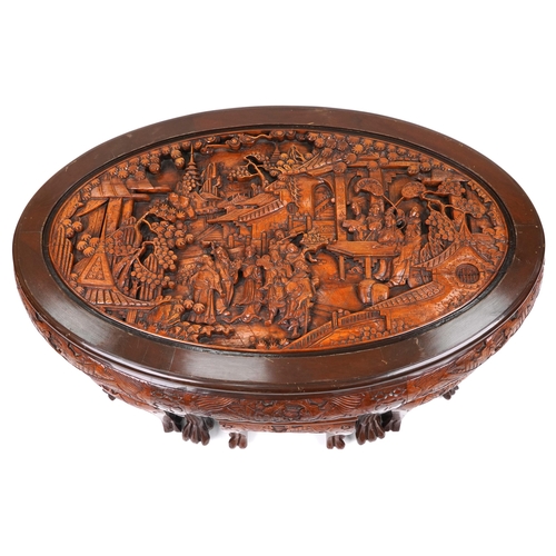 1143 - Nest of seven Chinese camphor wood occasional tables comprising an oval coffee table housing six occ... 