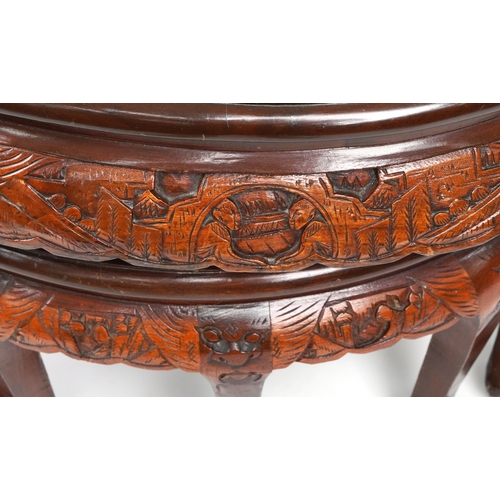 1143 - Nest of seven Chinese camphor wood occasional tables comprising an oval coffee table housing six occ... 