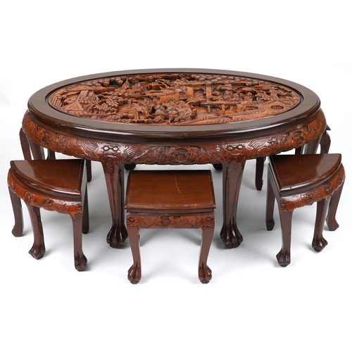 1143 - Nest of seven Chinese camphor wood occasional tables comprising an oval coffee table housing six occ... 