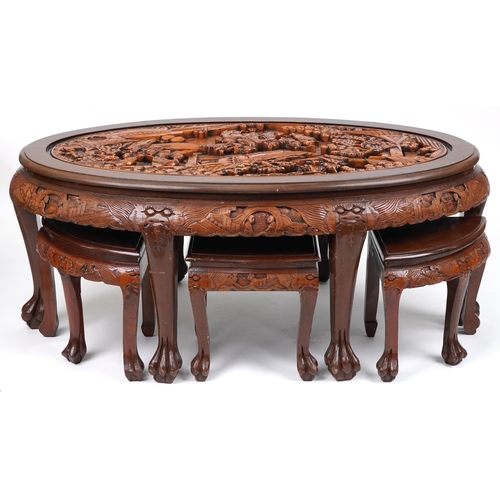 1143 - Nest of seven Chinese camphor wood occasional tables comprising an oval coffee table housing six occ... 