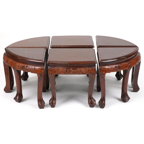 1143 - Nest of seven Chinese camphor wood occasional tables comprising an oval coffee table housing six occ... 