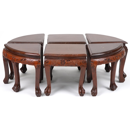 1143 - Nest of seven Chinese camphor wood occasional tables comprising an oval coffee table housing six occ... 