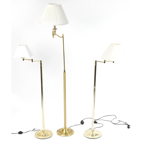 1190 - Three contemporary adjustable brass standard lamps with cream shades including a pleated example