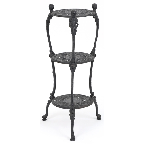 1205 - Victorian style cast iron three tier plant stand with figural mounts, 74cm high