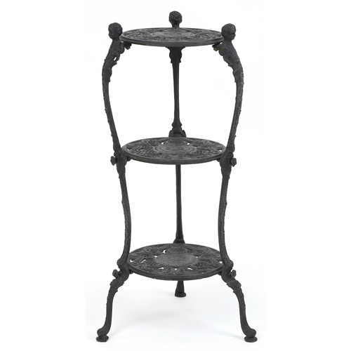 1205 - Victorian style cast iron three tier plant stand with figural mounts, 74cm high