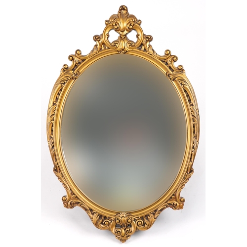 1239 - Ornate gilt framed oval wall mirror decorated with acanthus leaves, 72cm x 47cm