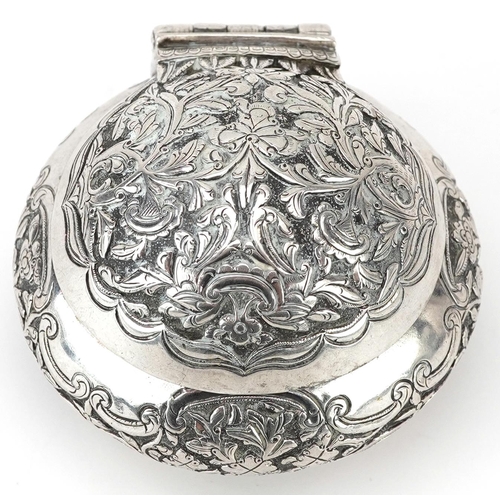 299 - Tibetan unmarked silver bun shaped box with hinged lid profusely embossed with flowers and foliage, ... 