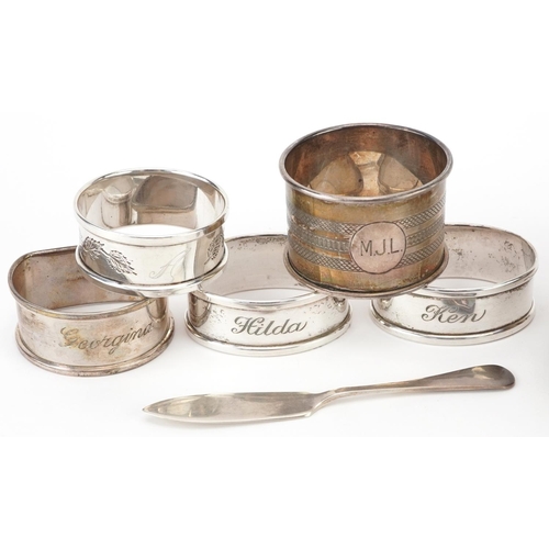 176 - Edwardian and later silver objects comprising five napkin rings, butter knife and shell shaped dish ... 