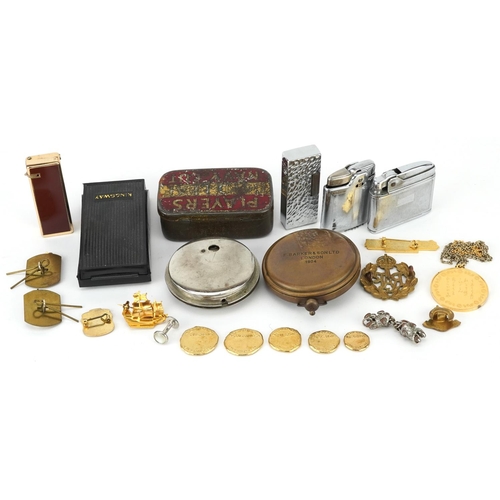 1284 - Sundry items including military cap badges, pocket lighters, a silver gilt pendant on necklace and a... 