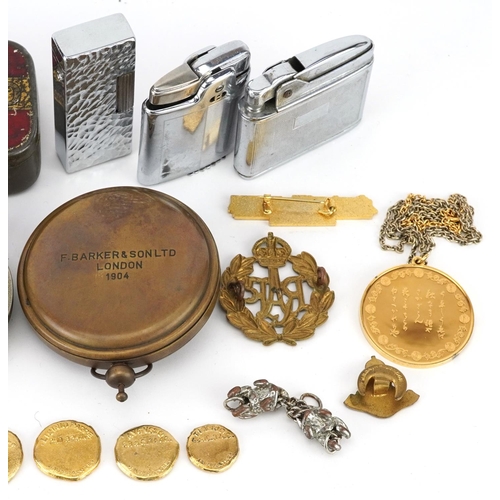 1284 - Sundry items including military cap badges, pocket lighters, a silver gilt pendant on necklace and a... 