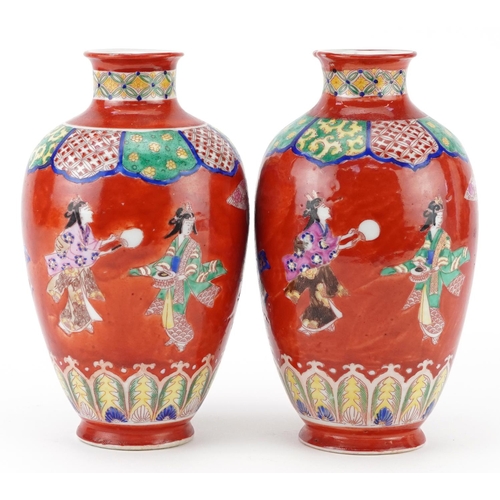 623 - Pair of Japanese iron red ground porcelain vases hand painted with a continuous band of Geishas danc... 