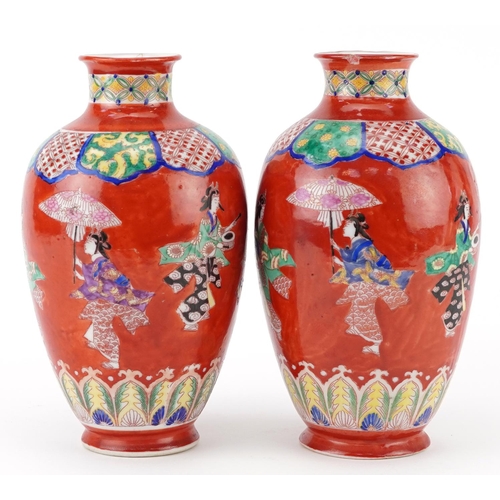 623 - Pair of Japanese iron red ground porcelain vases hand painted with a continuous band of Geishas danc... 