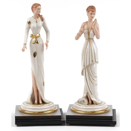 1430 - Pair of Italian porcelain figurines of females raised on silvered and ebonised stepped square bases,... 