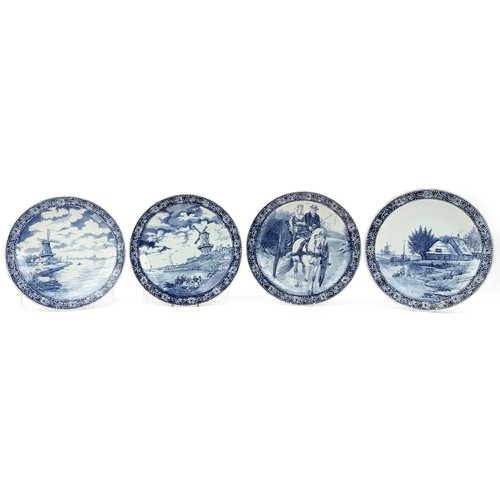 1423 - Boch, four Dutch Delft blue and white chargers including examples decorated after T Sonneville and M... 