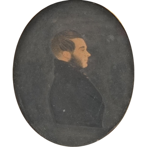 375 - Georgian oval silhouette portrait of a young gentleman housed in an ebonised frame, indistinctly ins... 