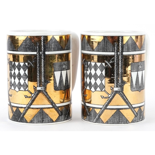 314 - Piero Fornasetti, pair of vintage Italian gold lustre mugs decorated with shields, each 12.5cm high