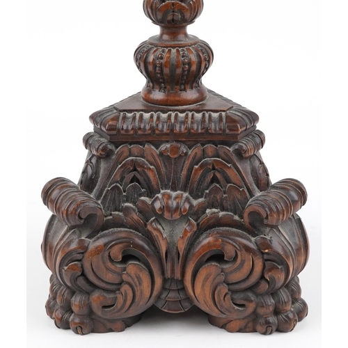 84 - Large antique oak candle holder profusely carved with foliage, overall 76cm high