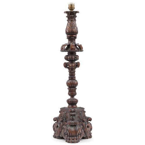 84 - Large antique oak candle holder profusely carved with foliage, overall 76cm high