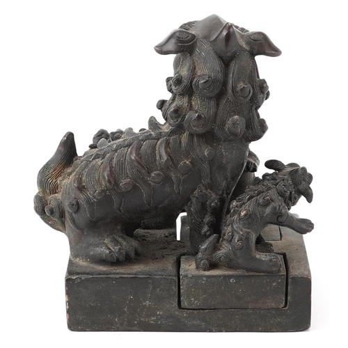 626 - Set of four Chinese patinated bronze interlocking desk seals in the form of qilins, 12cm high