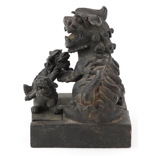 626 - Set of four Chinese patinated bronze interlocking desk seals in the form of qilins, 12cm high