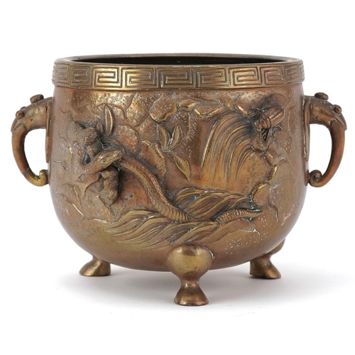 Japanese patinated bronze three footed censer with twin handles decorated in relief with serpents and animals, character marks to the base, 10cm high x 15cm wide