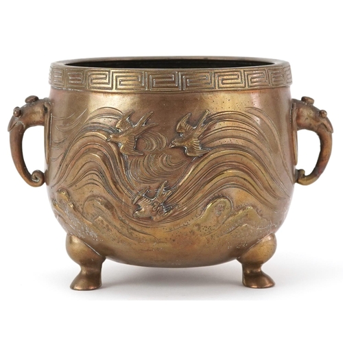 16 - Japanese patinated bronze three footed censer with twin handles decorated in relief with serpents an... 