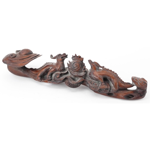 564 - Chinese hardwood ruyi sceptre carved with two dragons chasing the flaming pearl, 43cm wide