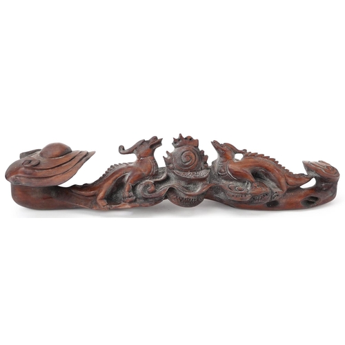 564 - Chinese hardwood ruyi sceptre carved with two dragons chasing the flaming pearl, 43cm wide