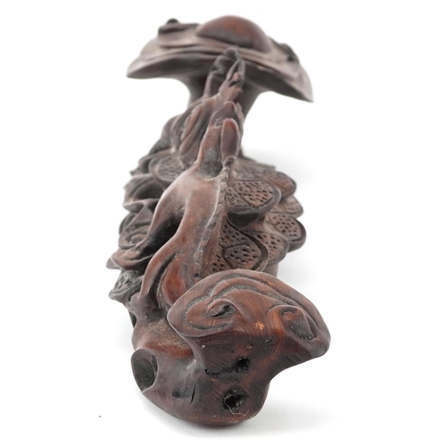 564 - Chinese hardwood ruyi sceptre carved with two dragons chasing the flaming pearl, 43cm wide