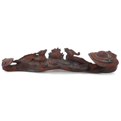 564 - Chinese hardwood ruyi sceptre carved with two dragons chasing the flaming pearl, 43cm wide