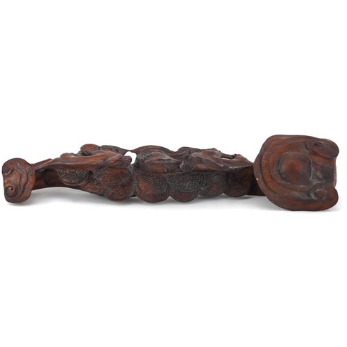 564 - Chinese hardwood ruyi sceptre carved with two dragons chasing the flaming pearl, 43cm wide