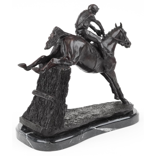 276 - Patinated bronze statue of a jockey on horseback raised on a shaped black marble base, 35cm in lengt... 