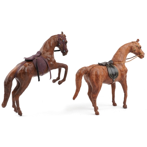 1549 - Manner of Liberty & Co, two leather covered horses including a rearing example, 40cm high