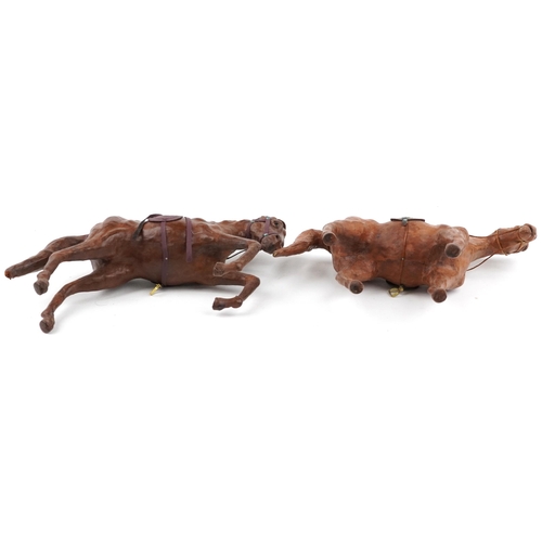 1549 - Manner of Liberty & Co, two leather covered horses including a rearing example, 40cm high