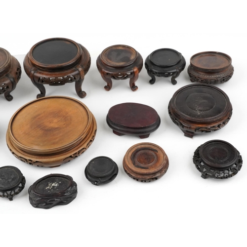 566 - Antique and later Chinese carved hardwood stands, some possibly Hongmu, the largest 19cm in diameter